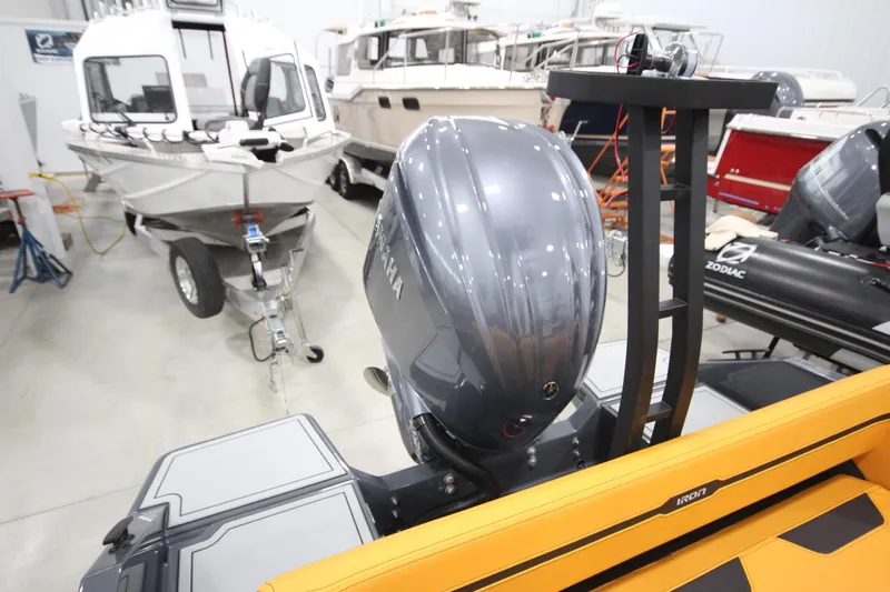 Slide: The Image of 2026 IRON BOATS IRON 767 with Yamaha engine in showroom, surrounded by other boats. - 10