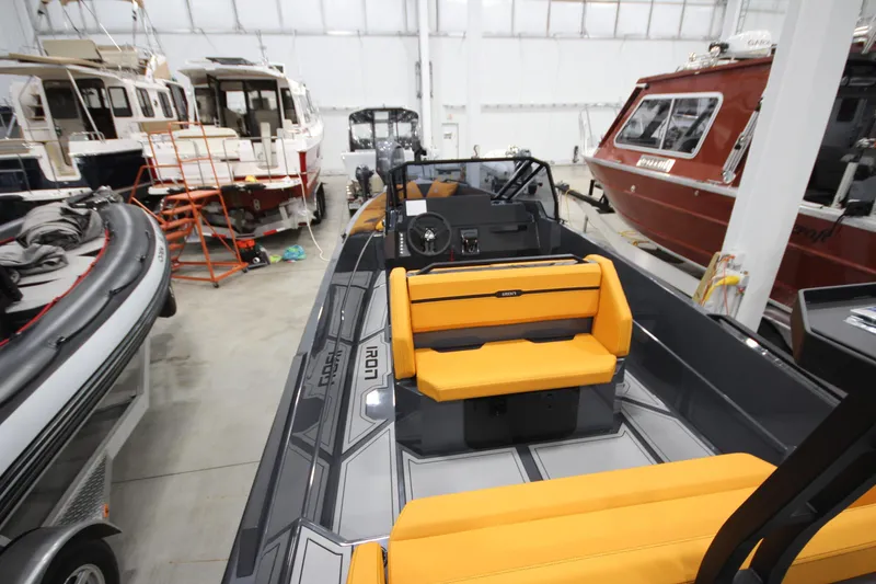Slide: The Image of 2026 IRON BOATS IRON 767 with yellow seating in a showroom. - 13