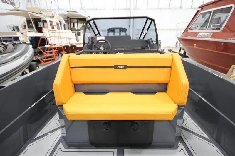 Slide: The Image of 2026 IRON BOATS IRON 767 with vibrant yellow seating in a showroom. - 16