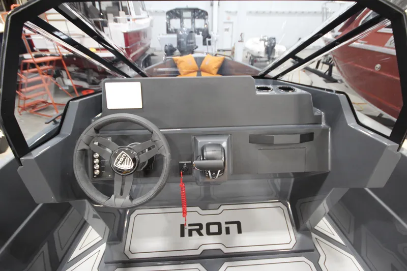 Slide: The Image of Interior view of 2026 IRON BOATS IRON 767 cockpit with steering wheel and controls. - 20