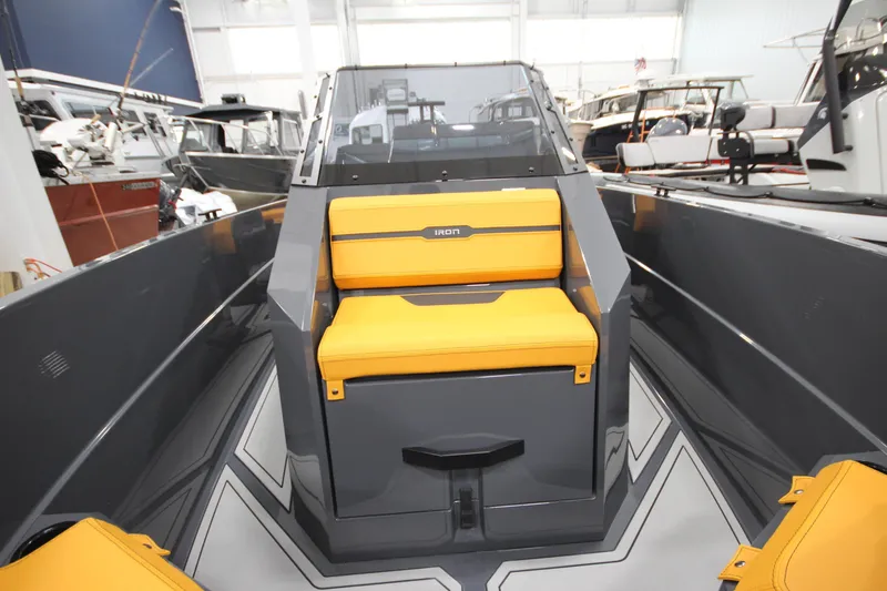 Slide: The Image of 2026 IRON BOATS IRON 767 with yellow seating, showcased in a boat showroom. - 22