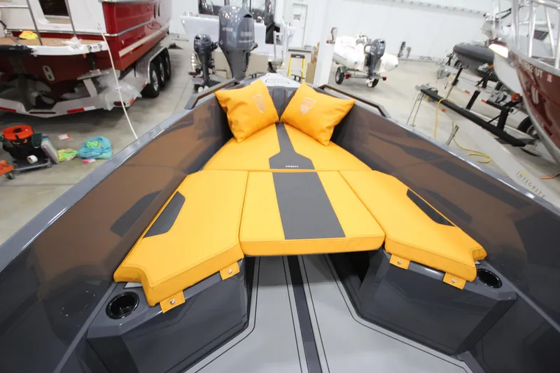 Slide: The Image of Interior view of 2026 IRON BOATS IRON 767 with orange cushions in a showroom. - 25