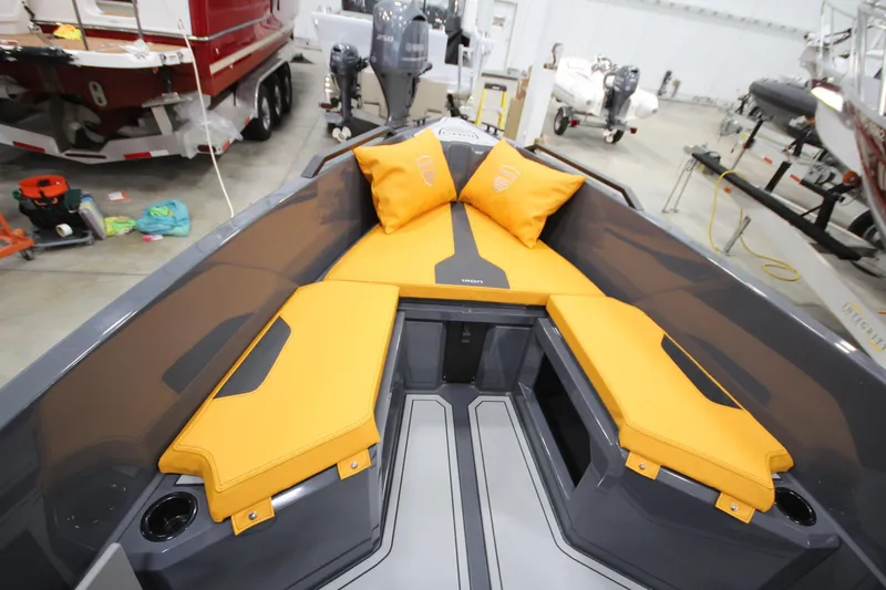 Slide: The Image of 2026 IRON BOATS IRON 767 with vibrant yellow seating in a showroom. - 26
