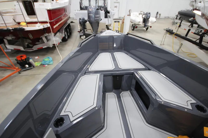 Slide: The Image of 2026 IRON BOATS IRON 767 interior view in a showroom with other boats. - 27