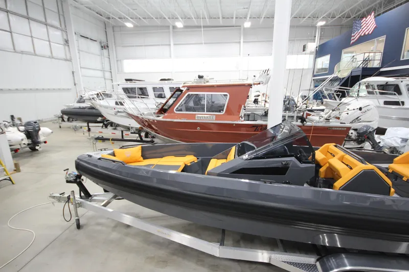 Slide: The Image of Indoor showroom displaying 2026 IRON BOATS IRON 767 with sleek design and vibrant seating. - 5