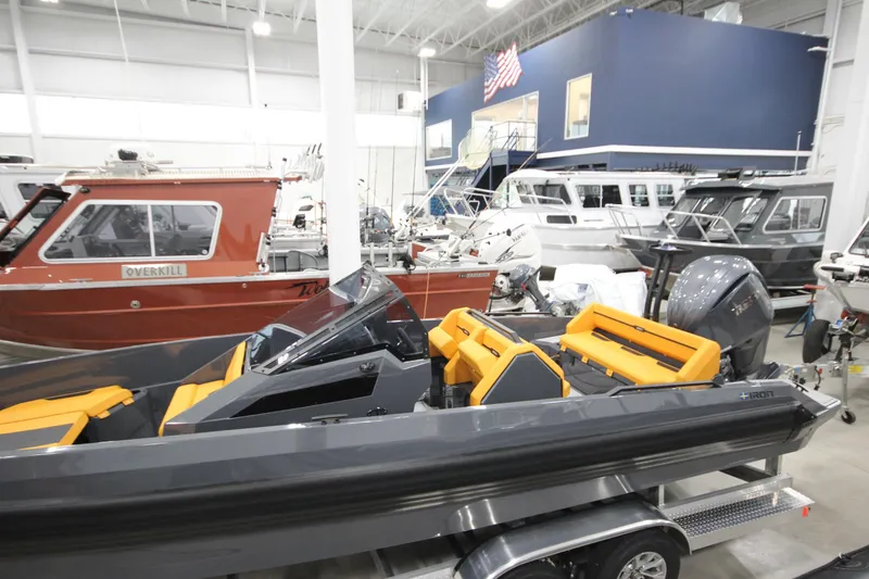Slide: The Image of 2026 IRON BOATS IRON 767 displayed in a showroom with other boats. - 6