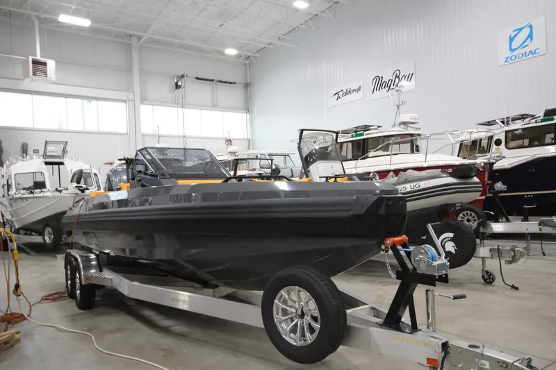Slide: The Image of 2026 IRON BOATS IRON 767 on trailer in showroom with other boats. - 8