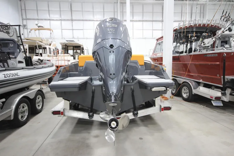 Slide: The Image of 2026 IRON BOATS IRON 767 motorboat in showroom, featuring powerful outboard engine. - 9