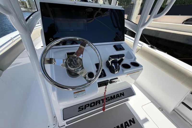 Slide: The Image of 2021 Sportsman Open 252 Center Console boat helm with steering wheel and controls. - 11
