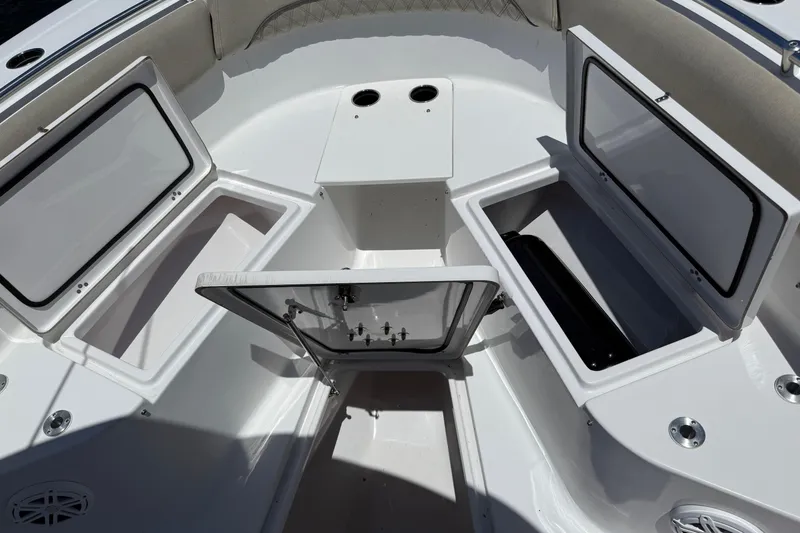 Slide: The Image of 2021 Sportsman Open 252 Center Console boat storage compartments open. - 15