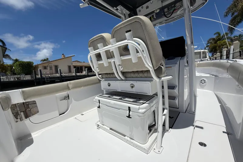 Slide: The Image of 2021 Sportsman Open 252 Center Console boat interior with seating and storage under a clear blue sky. - 3