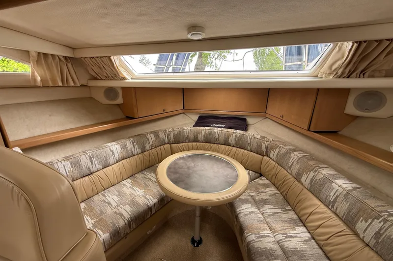 Slide: The Image of Interior of 1997 Bayliner 3255 Avanti boat with cozy seating and round table. - 12