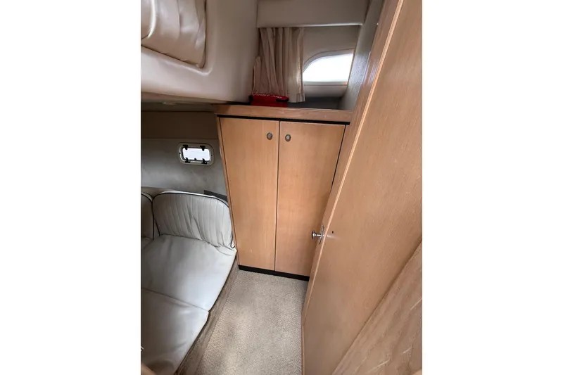 Slide: The Image of Interior of 1997 Bayliner 3255 Avanti boat with wood cabinetry and seating area. - 18