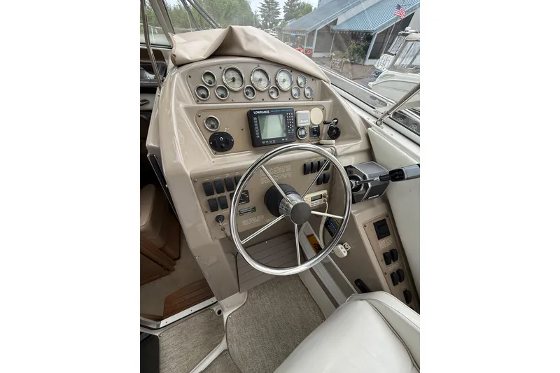 Slide: The Image of 1997 Bayliner 3255 Avanti helm with steering wheel, gauges, and navigation equipment. - 19