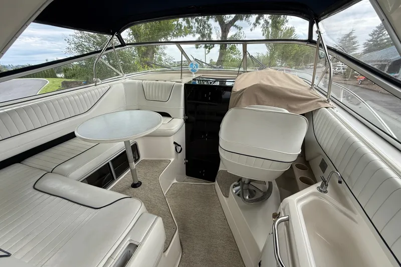 Slide: The Image of 1997 Bayliner 3255 Avanti boat interior with seating, table, and helm station. - 25