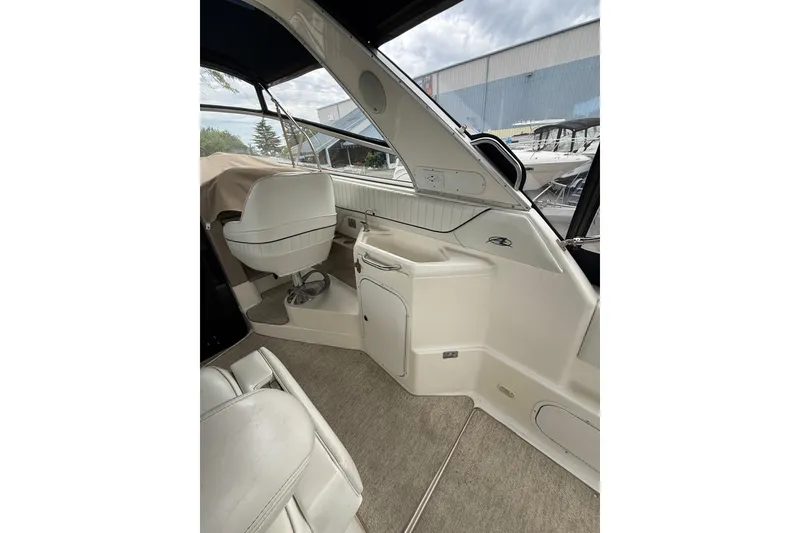 Slide: The Image of 1997 Bayliner 3255 Avanti boat interior with white seating and helm station. - 27