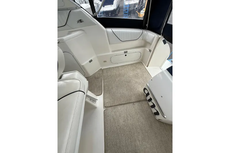Slide: The Image of Interior view of 1997 Bayliner 3255 Avanti boat with white seating and carpeted floor. - 28