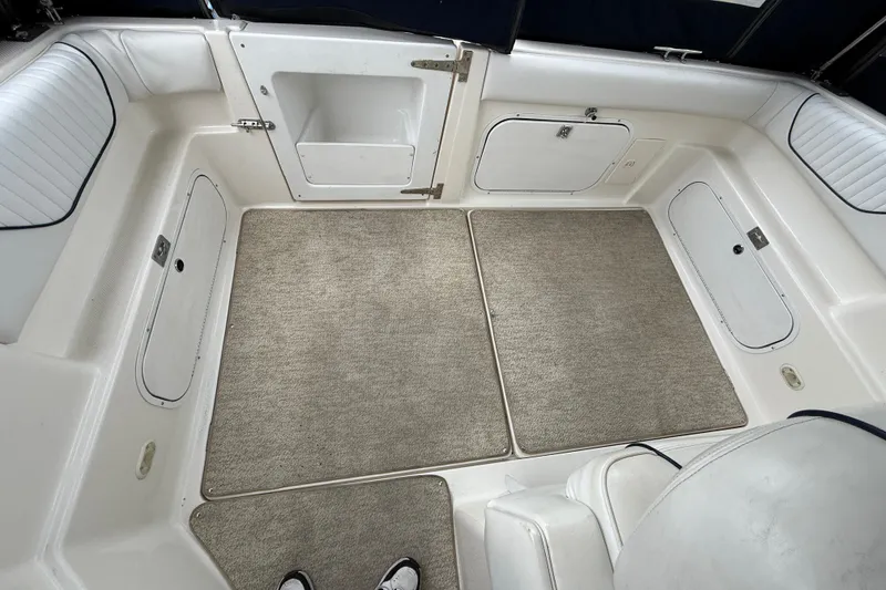 Slide: The Image of 1997 Bayliner 3255 Avanti boat interior with carpeted flooring and storage compartments. - 29