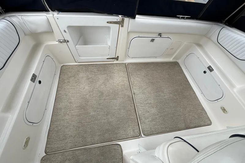 Slide: The Image of 1997 Bayliner 3255 Avanti boat interior with carpeted floor and storage compartments. - 30