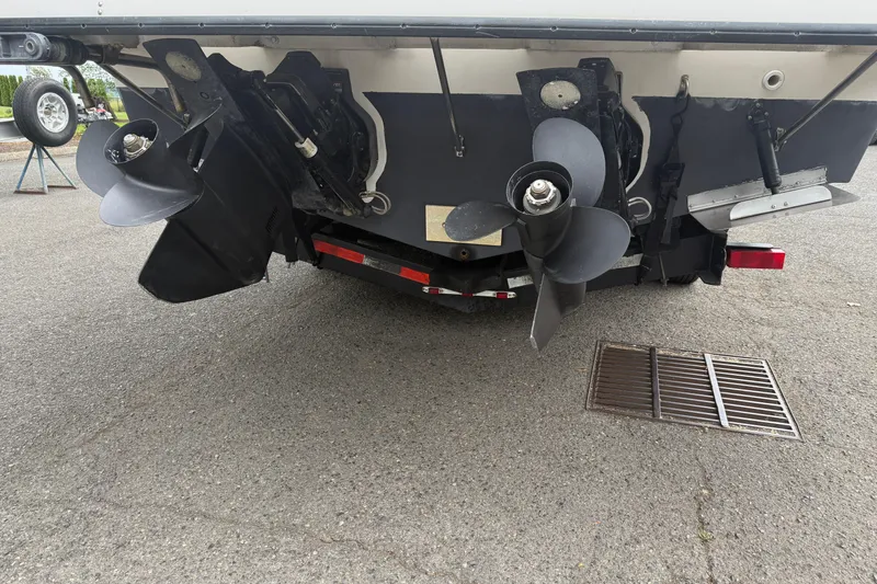 Slide: The Image of 1997 Bayliner 3255 Avanti boat stern with dual propellers on a trailer. - 4