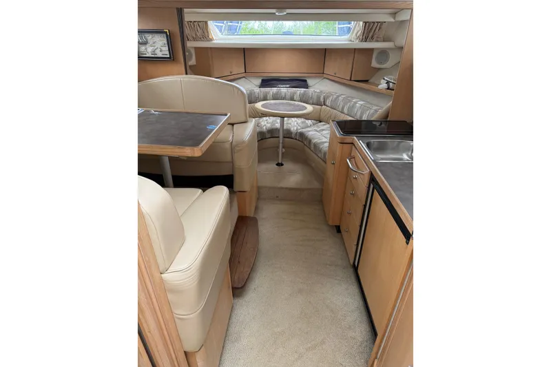 Slide: The Image of Interior of 1997 Bayliner 3255 Avanti boat with seating, table, and kitchenette. - 5