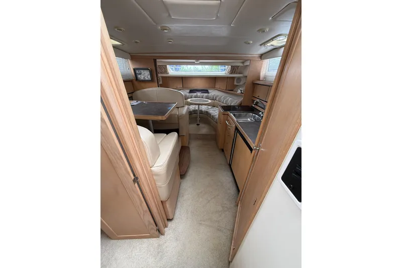 Slide: The Image of Interior of 1997 Bayliner 3255 Avanti boat with kitchen, seating, and dining area. - 6