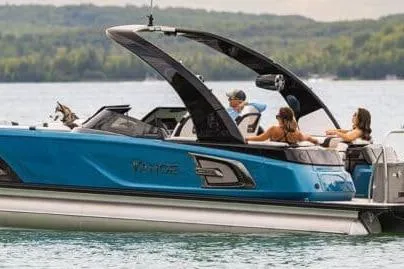 The Image of 2026 Tahoe boat on a lake with passengers enjoying the ride. - 0