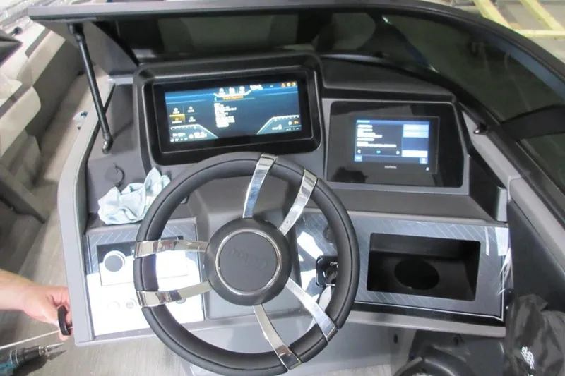 Slide: The Image of 2026 Tahoe boat dashboard with modern steering wheel and digital displays. - 10