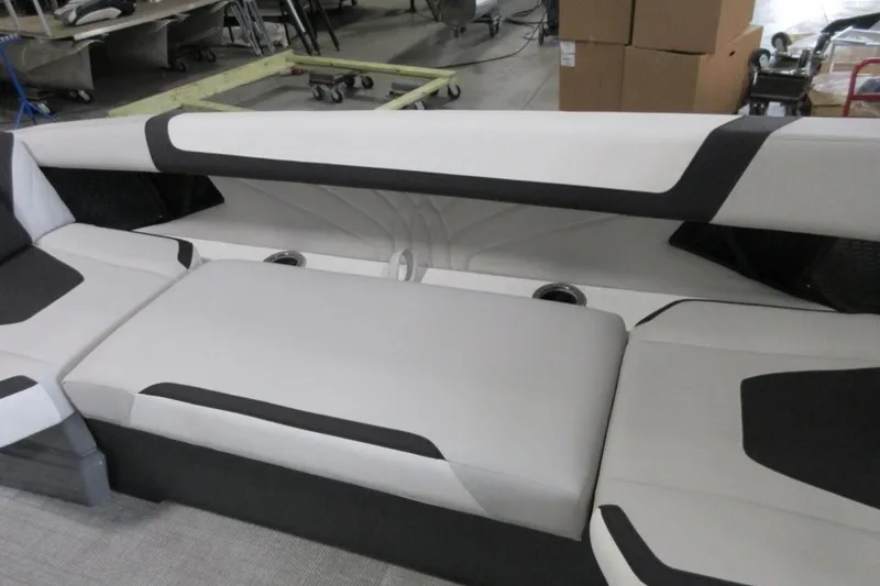 Slide: The Image of Modern 2026 Tahoe boat seating with sleek black and white design in a workshop setting. - 17