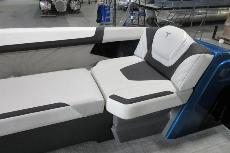 Slide: The Image of 2026 Tahoe boat interior with modern white and gray seating in a showroom. - 18