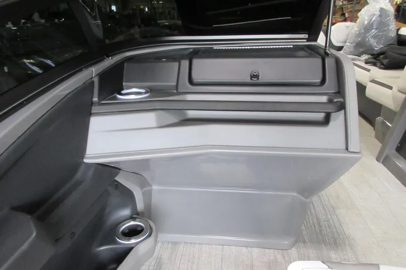 Slide: The Image of 2026 Tahoe boat interior with sleek gray storage compartment and cup holders. - 21