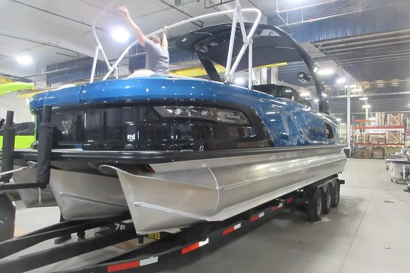 Slide: The Image of 2026 Tahoe pontoon boat in a showroom, featuring sleek design and modern amenities. - 3