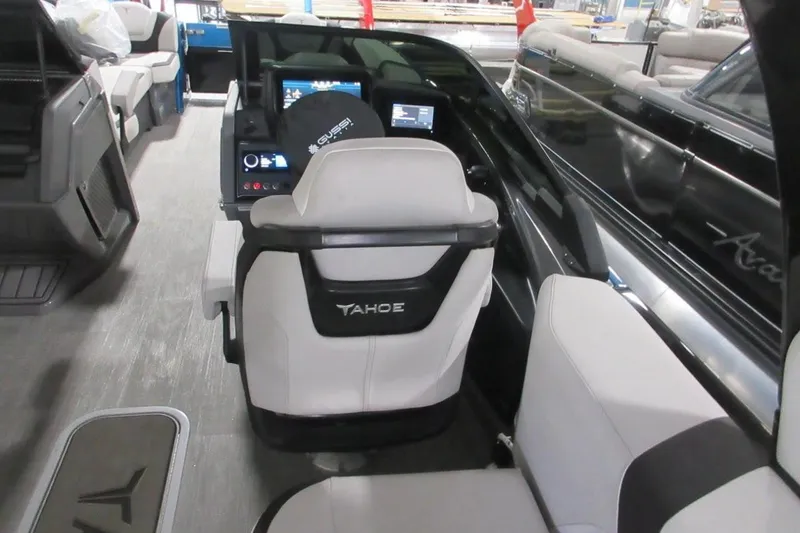 Slide: The Image of Interior of a 2026 Tahoe boat with modern dashboard and seating. - 33