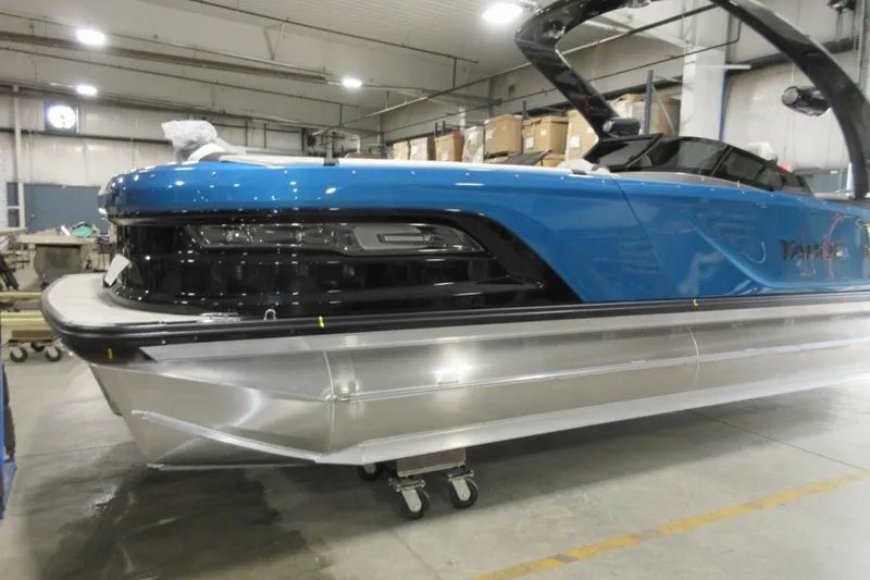Slide: The Image of 2026 Tahoe boat in a warehouse, featuring a sleek blue and silver design. - 4