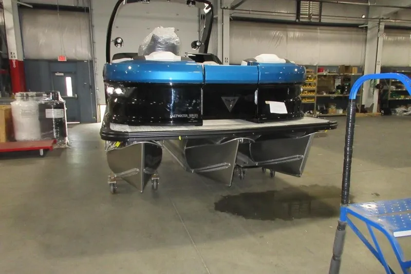 Slide: The Image of 2026 Tahoe pontoon boat in warehouse, featuring Saltwater Series design. - 8
