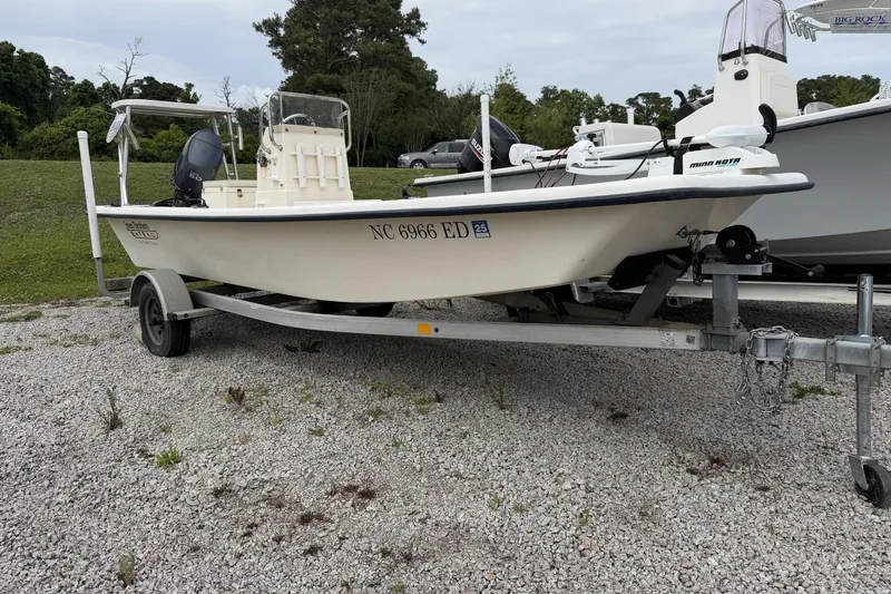 The Image of 2006 Jones Brothers Bateau 17 boat on trailer, parked on gravel lot. - 1
