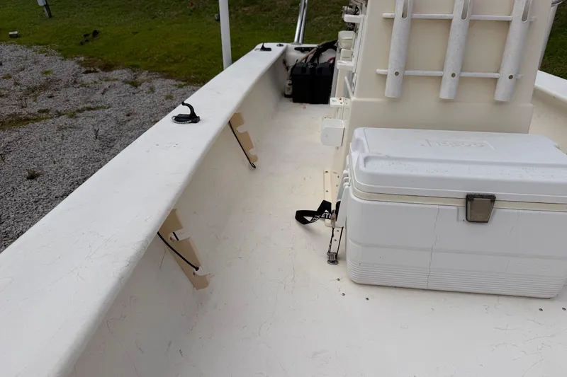 Slide: The Image of 2006 Jones Brothers Bateau 17 interior with cooler and rod holders on deck. - 8