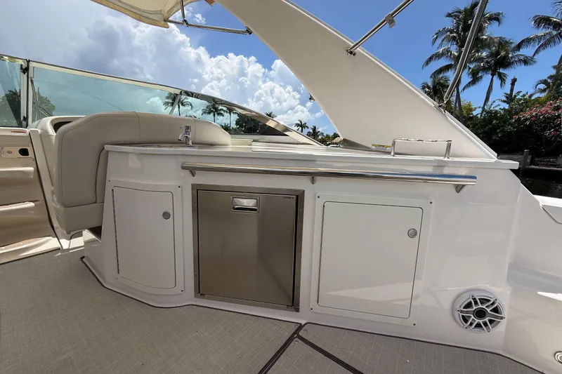 Slide: The Image of Luxury outdoor kitchen on 2022 Regal 33 XO yacht with sleek design and palm tree backdrop. - 13