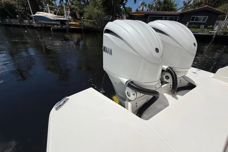 Slide: The Image of Twin Yamaha outboard engines on a 2022 Regal 33 XO boat docked by the water. - 7
