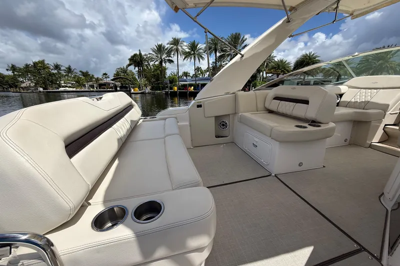 Slide: The Image of Luxurious 2022 Regal 33 XO boat interior with plush seating and cup holders. - 9