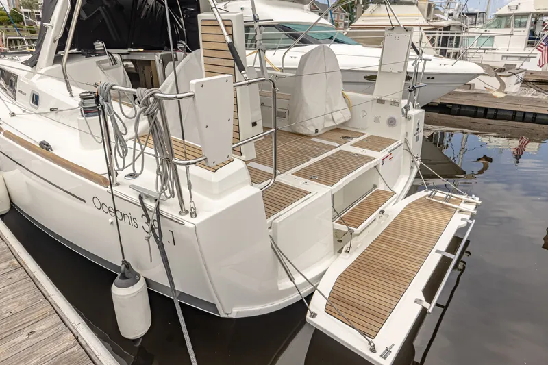 Slide: The Image of Beneteau Oceanis 38.1 Yacht 2023 at dock with wooden deck. - 13
