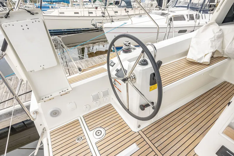 Slide: The Image of Helm of Beneteau Oceanis 38.1 yacht, 2023 model, featuring wooden deck. - 14