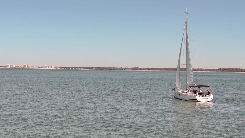 Slide: The Image of 2023 Beneteau Oceanis 38.1 sailboat on calm waters. - 22