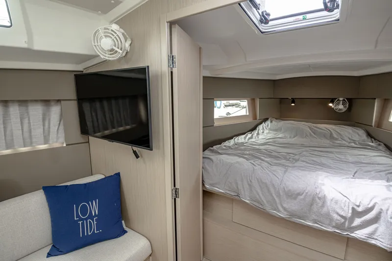 Slide: The Image of Interior of 2023 Beneteau Oceanis 38.1 yacht with bed and TV. - 5