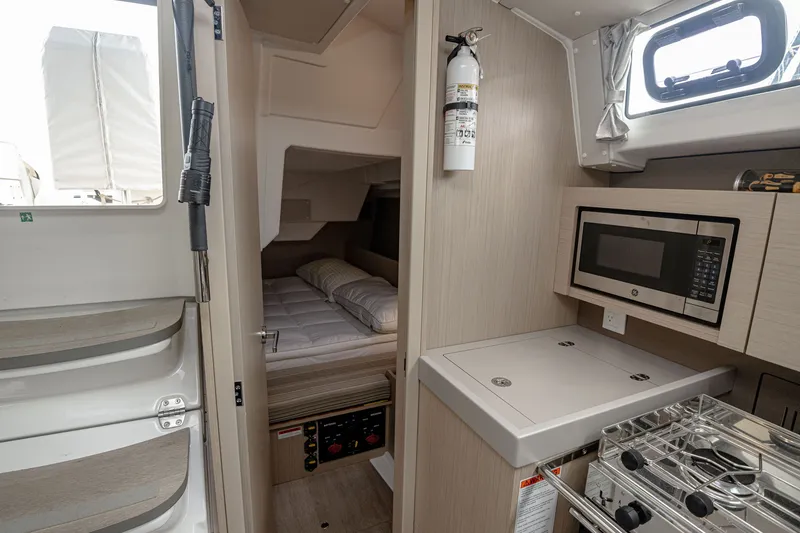 Slide: The Image of Interior of Beneteau Oceanis 38.1 yacht, kitchen and sleeping area, year 2023. - 8