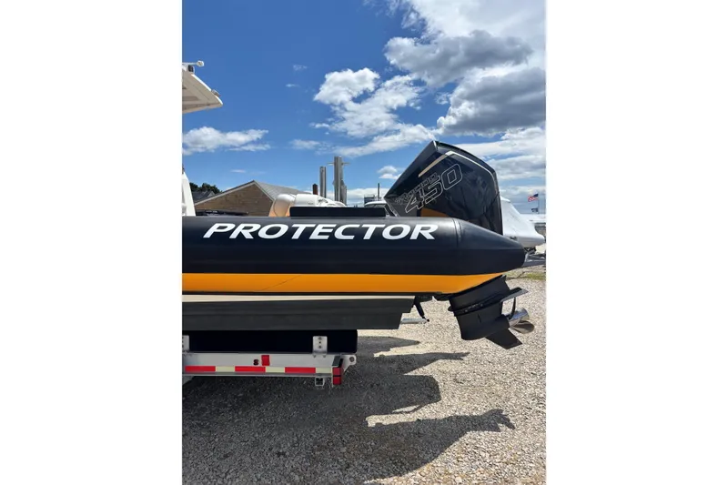 Slide: The Image of 2020 Protector 380 Targa boat with powerful engine, parked outdoors under a blue sky. - 15