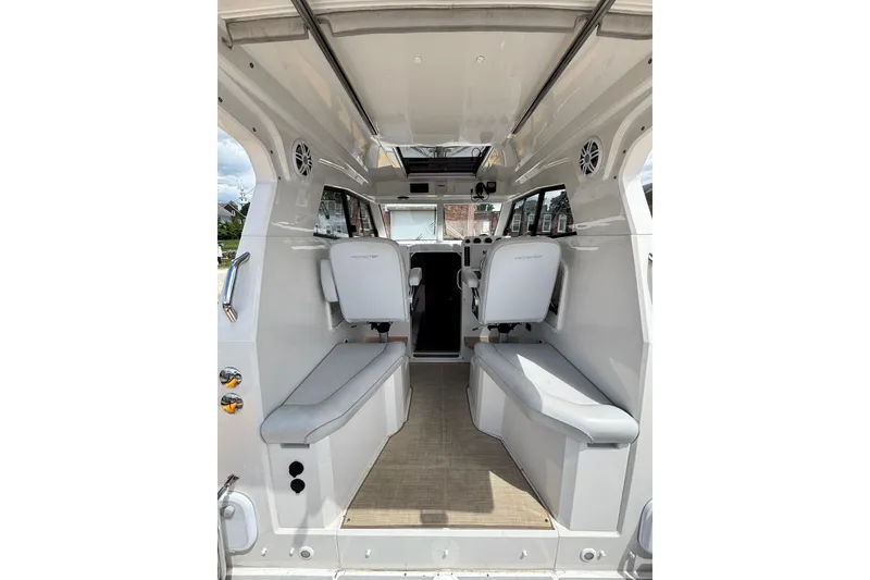 Slide: The Image of Interior of a 2020 Protector 380 Targa boat, featuring seating and modern design. - 19