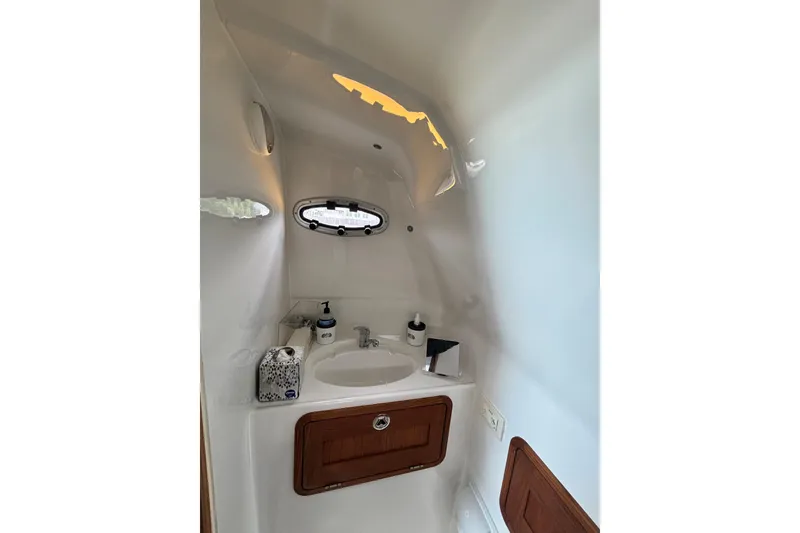 Slide: The Image of Compact bathroom interior of 2020 Protector 380 Targa boat with sink and porthole. - 25