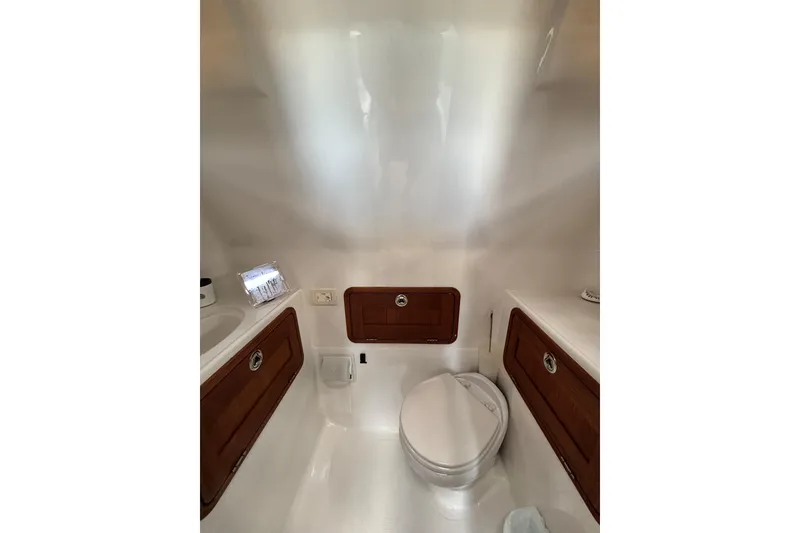 Slide: The Image of 2020 Protector 380 Targa boat bathroom with wooden cabinets and modern fixtures. - 26
