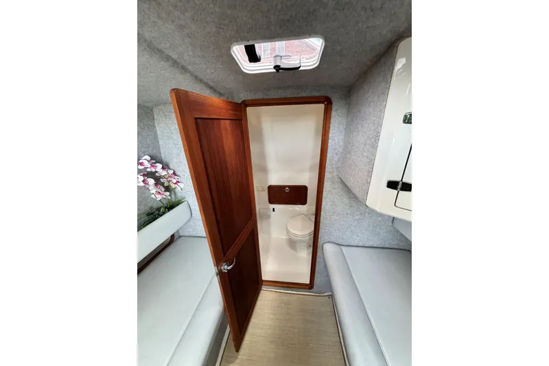 Slide: The Image of Interior of 2020 Protector 380 Targa boat with wooden door and compact bathroom. - 27